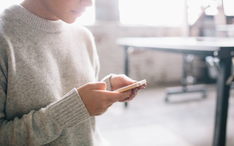 Woman Looking at Cell Phone. Credit: DeathtoStock_Creative Community5