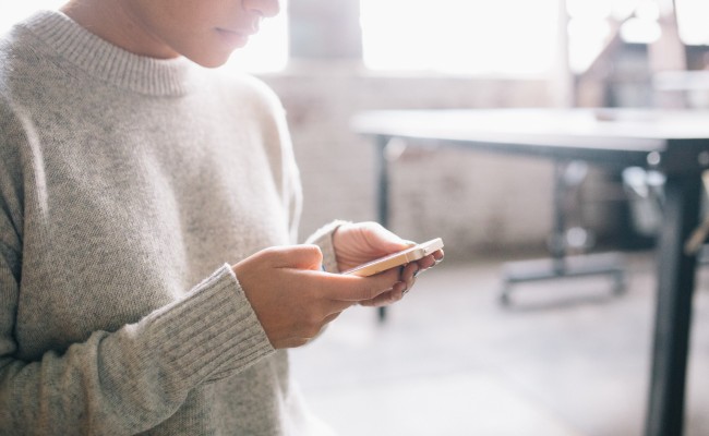 Woman Looking at Cell Phone. Credit: DeathtoStock_Creative Community5