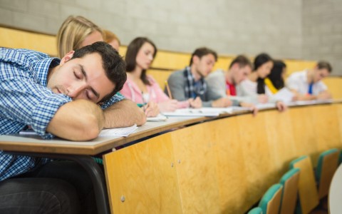 male-sleeping-with-students-in-lecture-hall-
