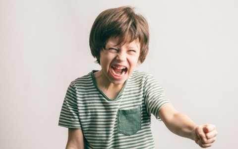 naughty boy defying mother