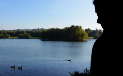 Woman beside a lake