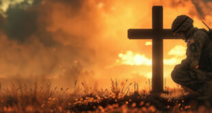 Christian soldier kneeling before a cross